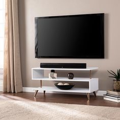 a flat screen tv sitting on top of a white entertainment center