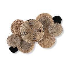 woven baskets are arranged on the floor in different sizes and shapes, with black accents