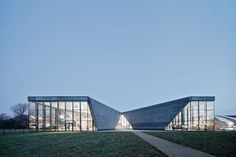 the building is made up of triangular shapes and has glass walls on each side, along with large windows