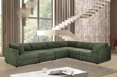 a living room with a sectional couch and coffee table in front of a spiral staircase