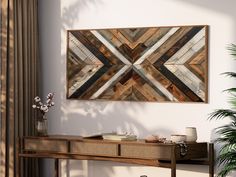 a wooden wall hanging over a table with vases and plants on top of it