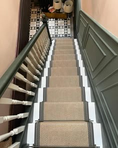 there is a coffee cup sitting on the top of this stair case next to some cups