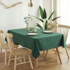 a green table cloth on a dining room table