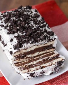 a piece of ice cream cake on a plate with a red and white checkered table cloth