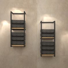 two wall mounted shelves with towels on them