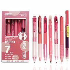 four different types of pens in pink packaging