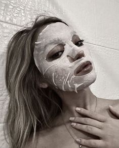 a woman wearing a white mask on her face