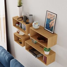 three wooden shelves with books, magazines and other items on them in a living room