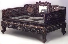 an ornately carved bed frame with mirrors on the top and bottom, is shown in news clipping