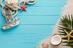 an arrangement of seashells and starfish on a blue wooden background