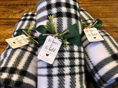 three black and white checkered blankets with tags on them