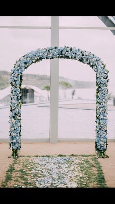 an arch decorated with blue and white flowers