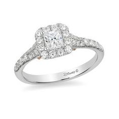 a white gold ring with diamonds on the sides and an oval shaped diamond in the center