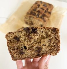 someone holding up a piece of bread with raisins on it