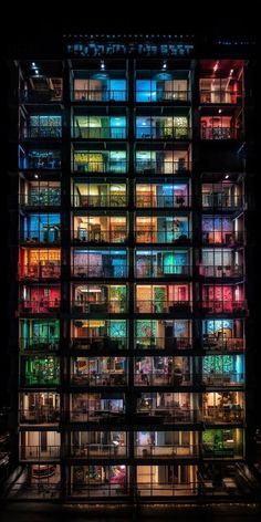 an illuminated building with many windows and balconies