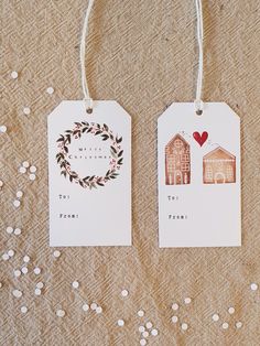 two tags that say i love you to the front and back with houses on them