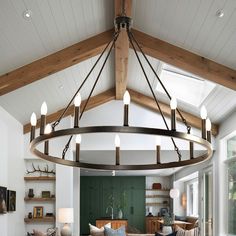 a living room filled with furniture and a large light fixture hanging from the center of the room