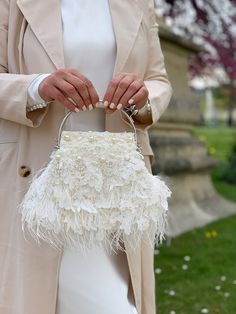 Elegant and vintage-looking light ivory wedding clutch is handmade and decorated with airy Italian lace and lovely chantilly Frech lace, pearl beads, seed beads, and finished with white ostrich feathers. The small whimsical bridal purse will be a great addition to your amazing look on the Special Day! The tiny fancy evening bag will be a lovely accessory not only for the bride but also will suit the bridesmaids' outfit, Mother of the bride, or Mother-in-law festive look. And after the celebration is over - you can take it with you to the costume party in Great Gatsby style, or date as an extraordinary stylish accent! 🤍Dimensions of the kiss lock bridal bag: 8"x6.5 '', with handle - 10"x8.5" / 20cm x 17cm, with handle - 20cm x 22 cm 🤍The weight of the bedazzled handbag is 0,88 lb (400 g) Great Gatsby Fashion, Bridal Purse, Bridal Bag, Ivory Flower, Gatsby Style, Wedding Purse, Wedding Clutch, Light Ivory, Ivory Flowers