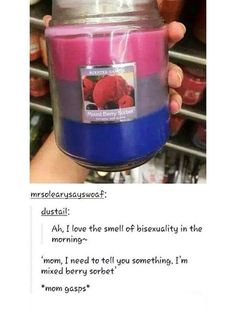 someone holding up a pink and blue candle