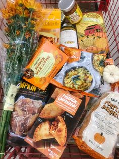 a shopping cart filled with lots of food and snacks in it's side basket