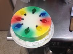 a rainbow cake sitting on top of a counter