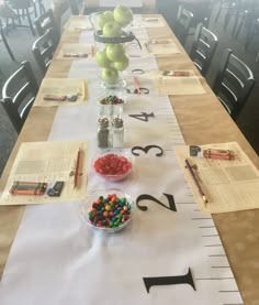 a long table with numbers and candy on it