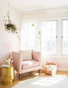 a living room filled with furniture and a potted plant on the side of the wall