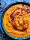 a blue bowl filled with food on top of a table