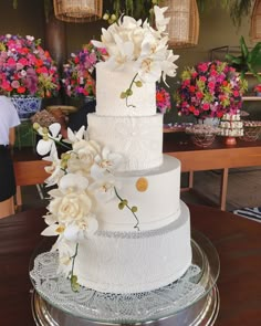 a three tiered cake with white flowers on top