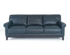 a blue leather couch sitting on top of a white floor