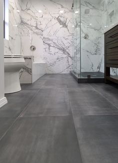 a large bathroom with marble walls and flooring