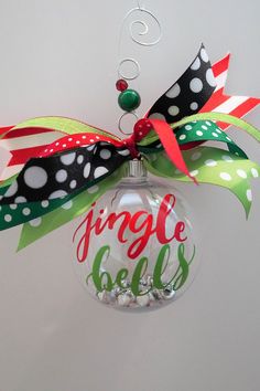 a christmas ornament hanging from the ceiling with ribbon and polka dots on it