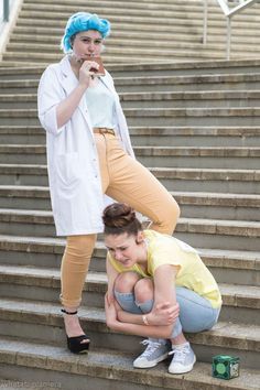 two women in costumes are on the stairs