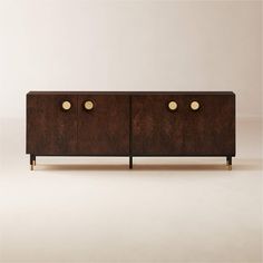 the sideboard is made out of wood and has brass knobs on each drawer