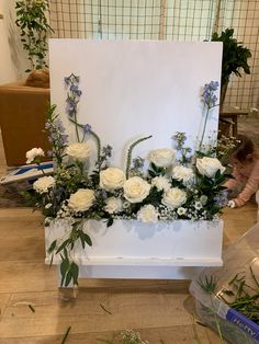 a white flower arrangement sitting on top of a table