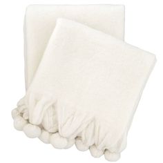 two white towels with pom - poms on them