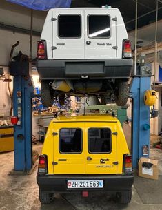 a yellow vehicle is parked in a garage