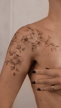 a woman's arm with flowers on it