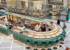 an overhead view of a restaurant with people walking around the counter and eating at it