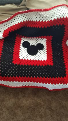 a crocheted blanket with mickey mouse on it