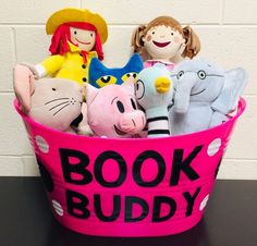 a pink bucket filled with stuffed animals on top of a table