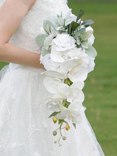 a bride holding a bouquet of white flowers