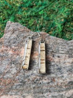 Dainty Mini Stix are a fan favourite! Ethically sourced white birch bark set in skinny rectangular tabs of .999 antiqued silver. Eco-friendly genuine white birch bark & copper earrings, topped with clear resin. All of the bark used in our jewellery is ethically sourced and not harvested from live trees. The white birch we use comes from Northern Ontario Canada and carries within it, the energy of our Great Canadian Wilderness. Birch is believed to ward off evil, banish fears and build courage. Associated with beauty and tolerance, it heightens tolerance of oneself and others. The birch tree symbolizes a fresh start and can bring courage and determination to those of us who are treading the path of spiritual growth. Although the birch does appear fragile, it is in fact extremely hardy. This Birch Bark Jewelry, Birch Bark Crafts Diy, Bark Jewelry, Birch Bark Earrings, Birch Jewelry, Birch Bark Crafts, Canadian Wilderness, Pill Bottle, Northern Ontario