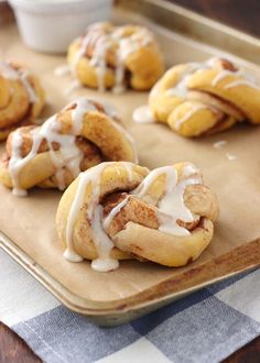 cinnamon rolls with icing on a baking sheet