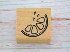 a rubber stamp with an image of a slice of orange on it's surface