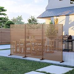 a wooden screen in the middle of a yard