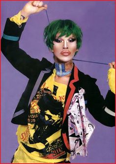 a woman with green hair and piercings on her neck is posing for the camera