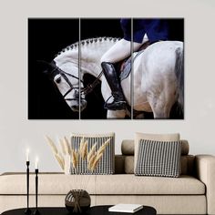 a white horse with rider on it's back in front of a black background