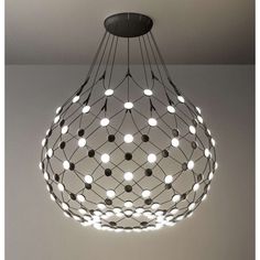 the light fixture is made from wire and has many balls hanging from it's center