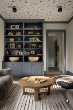 a living room filled with furniture and bookshelves